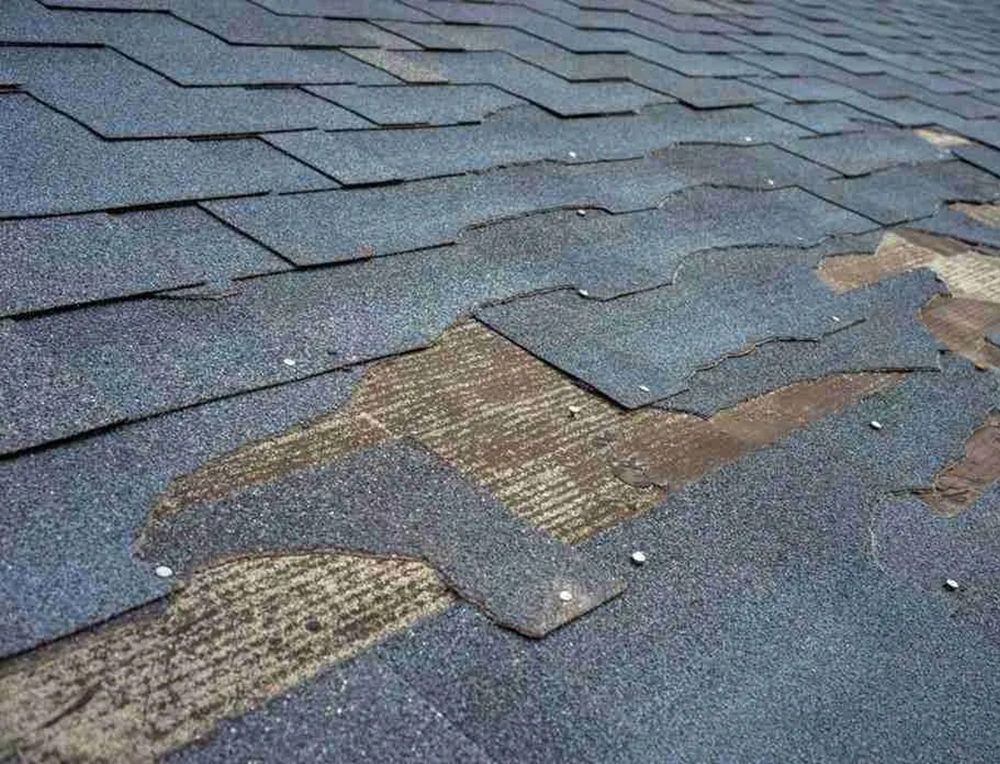 Roof damage with old shingles