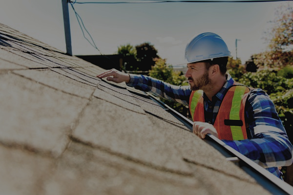 roofer inspecting a residential roof